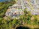 Aerial view of homes surrounded by lush greenery, lake, and community streets, with a swimming pool at 6006 Mount Zion Cir, Deland, FL 32724