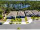 Aerial view of the neighborhood, showcasing houses near a lake with lush trees and paved streets at 6006 Mount Zion Cir, Deland, FL 32724