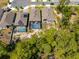 Aerial view of a home with a screened-in pool, nestled among trees, backing onto a wooded area at 6006 Mount Zion Cir, Deland, FL 32724