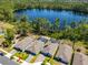 Aerial view showcasing the community homes near a serene lake with lush landscaping and a swimming pool at 6006 Mount Zion Cir, Deland, FL 32724
