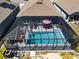 Aerial view of a home with screened-in pool area, covered seating, and solar panels at 6006 Mount Zion Cir, Deland, FL 32724