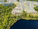Aerial shot showcasing home's lakeside location with community and pool at 6006 Mount Zion Cir, Deland, FL 32724