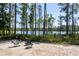 Backyard featuring a seating area with chairs and a scenic view of the lake and lush greenery at 6006 Mount Zion Cir, Deland, FL 32724