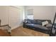 Cozy bedroom with a dark leather sofa, a wicker chair, and neutral colored carpet at 6006 Mount Zion Cir, Deland, FL 32724