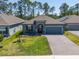 Inviting single-story home with well-kept landscaping, a two-car garage, and a welcoming front entrance at 6006 Mount Zion Cir, Deland, FL 32724