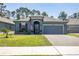 Charming single-story home with a two-car garage, neat landscaping, and an inviting front entrance at 6006 Mount Zion Cir, Deland, FL 32724