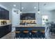 This open kitchen boasts a large island with seating, pendant lighting, and stainless steel appliances at 6006 Mount Zion Cir, Deland, FL 32724