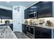 Modern kitchen features dark cabinets, stainless steel appliances, granite counters, and tiled backsplash at 6006 Mount Zion Cir, Deland, FL 32724