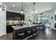 Modern kitchen featuring a central island with barstool seating, sleek dark cabinetry, and stainless steel appliances at 6006 Mount Zion Cir, Deland, FL 32724