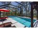 Screened-in pool area with an inground pool, outdoor seating, and beautiful view of the lake at 6006 Mount Zion Cir, Deland, FL 32724