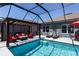 Relaxing screened-in pool area with outdoor seating, a sun decoration, and lounge chairs at 6006 Mount Zion Cir, Deland, FL 32724