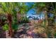 Backyard view with brick path and lush tropical landscape at 605 Goodall Ave, Daytona Beach, FL 32118