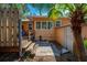 Exterior view of backyard with tropical landscaping, fence, patio, and deck at 605 Goodall Ave, Daytona Beach, FL 32118