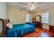 Comfortable bedroom with wood floors, ceiling fan, and traditional furnishings at 605 Goodall Ave, Daytona Beach, FL 32118