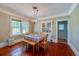Bright dining room with hardwood floors, a chandelier, and built-in cabinetry, ideal for Gathering meals and entertaining guests at 605 Goodall Ave, Daytona Beach, FL 32118