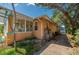 Exterior view of home with a sunroom addition and driveway at 605 Goodall Ave, Daytona Beach, FL 32118