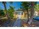 Inviting front exterior of a home with a screened porch, lush landscaping, and a walkway leading to the entrance at 605 Goodall Ave, Daytona Beach, FL 32118
