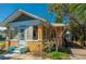 Charming home featuring a stucco exterior with ample natural light, a quaint entrance, and landscaped surroundings at 605 Goodall Ave, Daytona Beach, FL 32118