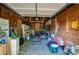 Unfinished garage interior with wooden walls and visible ceiling framework, providing a versatile storage space at 605 Goodall Ave, Daytona Beach, FL 32118