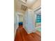 Hallway with hardwood floors, closet, and bathroom with shower/tub combination at 605 Goodall Ave, Daytona Beach, FL 32118