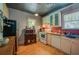 Functional kitchen featuring white appliances, wood cabinets, and red mosaic tile backsplash at 605 Goodall Ave, Daytona Beach, FL 32118