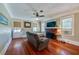 Comfortable living room with a brick fireplace, hardwood floors, and plenty of natural light, creating a welcoming atmosphere at 605 Goodall Ave, Daytona Beach, FL 32118
