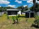 View of the home's backyard and the screened in porch at 606 W Voorhis Ave, Deland, FL 32720