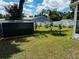 Expansive backyard featuring lush greenery, a storage shed and ample space for outdoor activities at 606 W Voorhis Ave, Deland, FL 32720