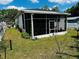 A view of the backyard with a screen enclosed patio at 606 W Voorhis Ave, Deland, FL 32720