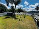 View of the backyard with trees and a white fence at 606 W Voorhis Ave, Deland, FL 32720
