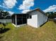 A view of the back of the property with a screened in porch at 606 W Voorhis Ave, Deland, FL 32720