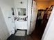 Well-lit bathroom featuring a white vanity, dark floors, and a walk-in closet at 606 W Voorhis Ave, Deland, FL 32720