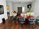 Bright dining area with a modern table, hardwood floors, and access to the living room at 606 W Voorhis Ave, Deland, FL 32720