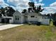 Charming single-story home featuring stucco siding, a neatly kept lawn, and a welcoming front porch at 606 W Voorhis Ave, Deland, FL 32720
