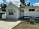 Inviting home exterior showcasing a well-manicured lawn, updated facade, and convenient parking at 606 W Voorhis Ave, Deland, FL 32720