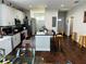 Modern kitchen boasts stainless steel appliances, granite countertops, and dark hardwood floors at 606 W Voorhis Ave, Deland, FL 32720