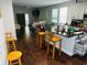 Bright, open kitchen featuring hardwood floors, a breakfast bar, and an adjacent living area at 606 W Voorhis Ave, Deland, FL 32720