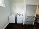 Clean laundry room featuring a washer, dryer, and dark hardwood floors at 606 W Voorhis Ave, Deland, FL 32720
