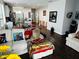 Inviting living room showing dark hardwood floors, white sofas, and an open floorplan at 606 W Voorhis Ave, Deland, FL 32720