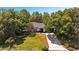 Aerial view of a well-maintained single-story home with mature trees and a long private driveway at 639 Elwood St, Deltona, FL 32725