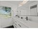 Bright bathroom with dual sinks, stone countertops, and updated black hardware at 639 Elwood St, Deltona, FL 32725