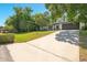 A long driveway leads to this updated house with a well-maintained front yard and beautiful landscaping at 639 Elwood St, Deltona, FL 32725