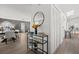 Stylish entryway featuring a decorative table with a round mirror, leading into a living and dining space at 639 Elwood St, Deltona, FL 32725