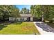 Charming single-story home featuring a lush front yard, brick accents, and attached two-car garage at 639 Elwood St, Deltona, FL 32725