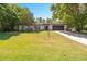 Charming single-story home with well-manicured front yard, mature trees, and a two-car garage at 639 Elwood St, Deltona, FL 32725