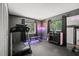Home gym with treadmill, weights, and neon peach decor at 639 Elwood St, Deltona, FL 32725