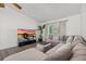 Comfortable living room area featuring neutral-toned furniture, a large TV, and stylish decor at 639 Elwood St, Deltona, FL 32725