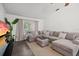 Cozy living room featuring a large sectional sofa, hardwood floors, and natural light at 639 Elwood St, Deltona, FL 32725