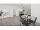 Bright living room featuring hardwood floors, comfortable furniture and view into a bedroom at 639 Elwood St, Deltona, FL 32725