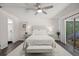 Bright main bedroom features modern ceiling fan, dark floors, and ensuite bathroom and balcony access at 639 Elwood St, Deltona, FL 32725